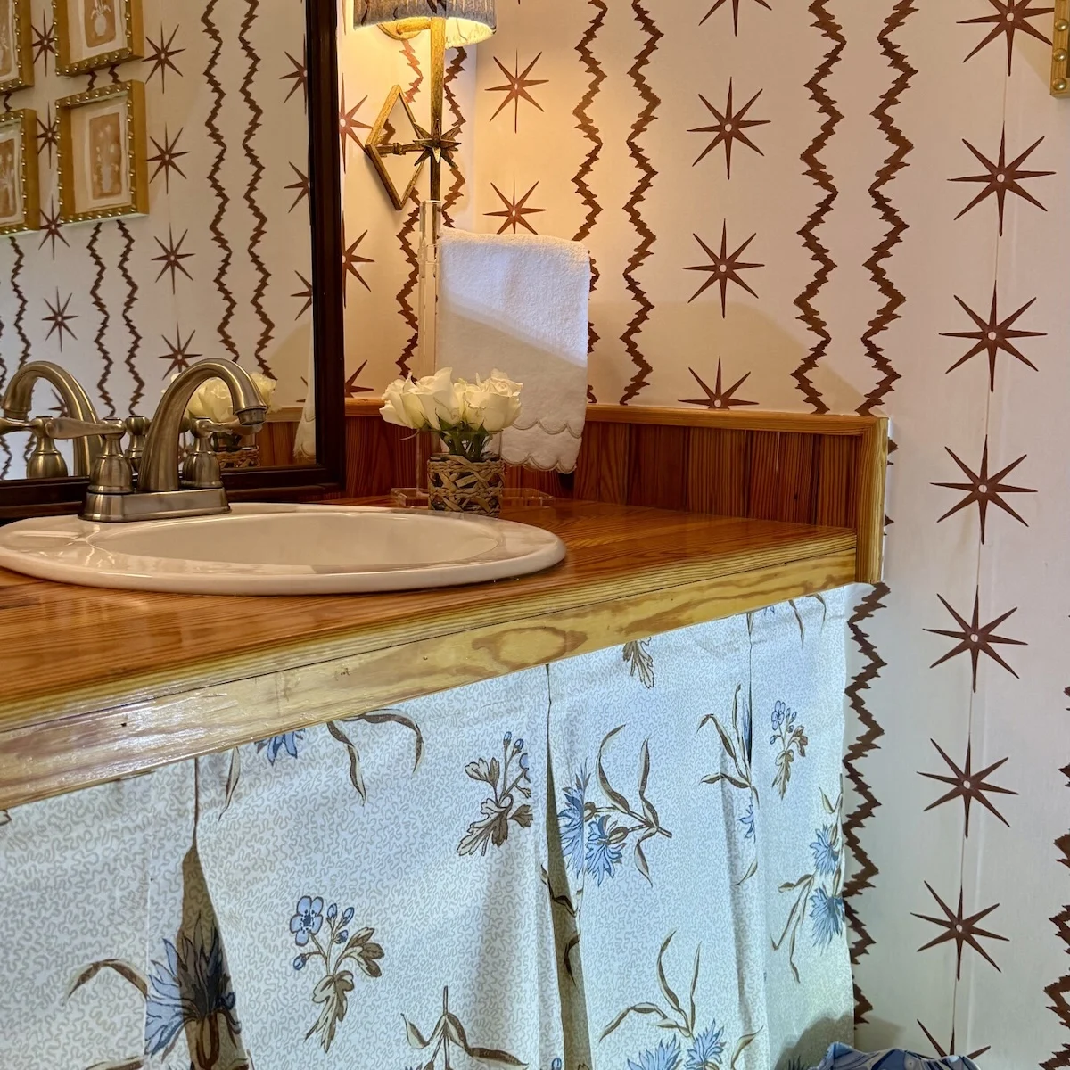 Powder room with Spoonflower wallpaper and DIY Spoonflower fabric sink skirt.